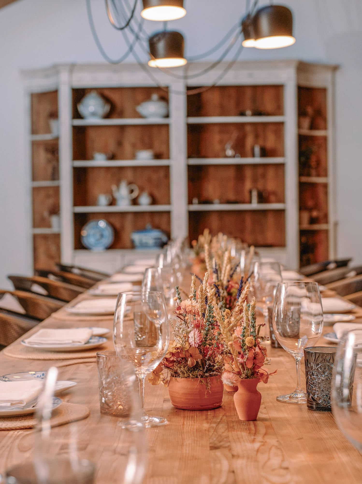 a table with glasses and flowers on it