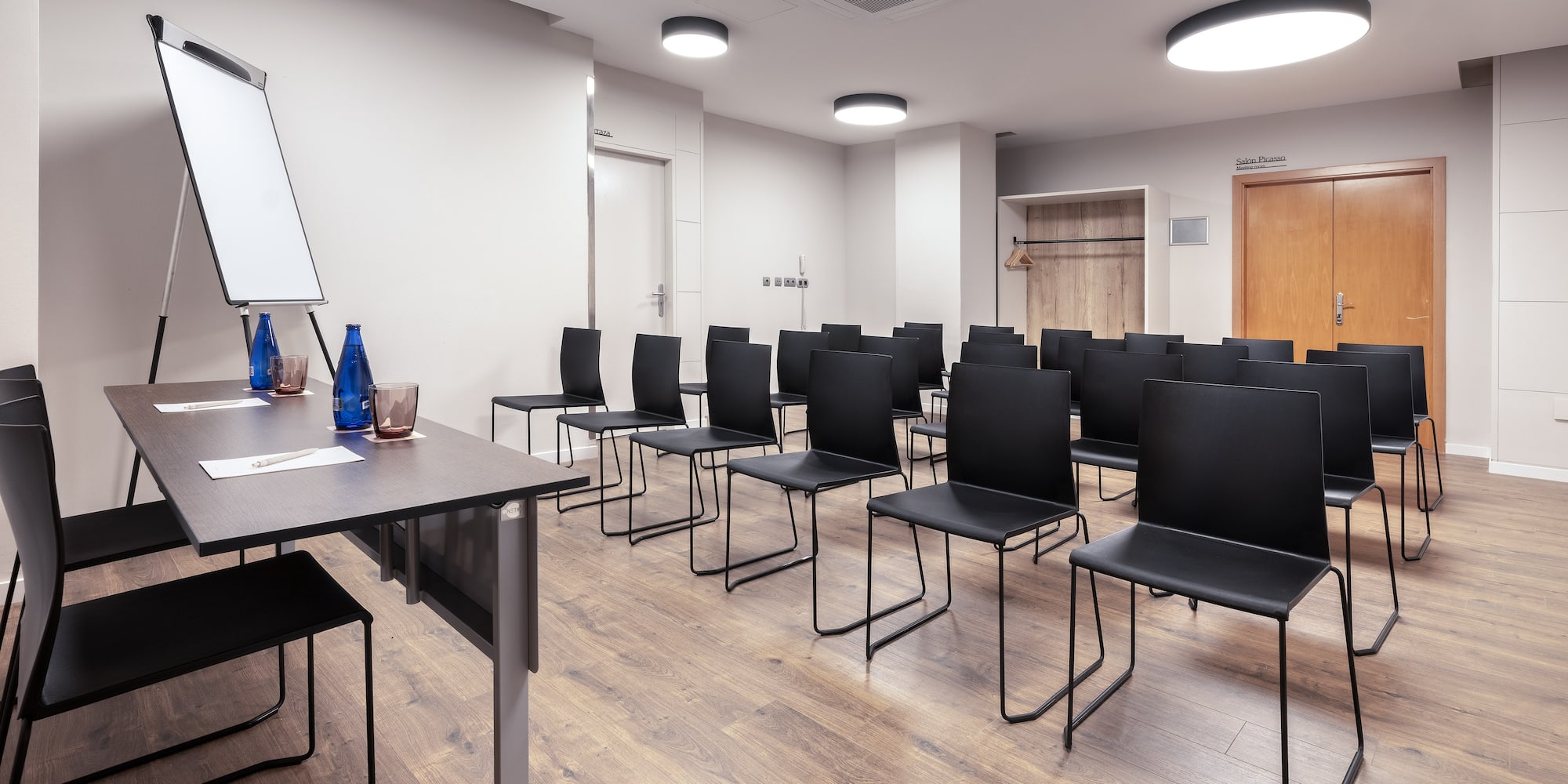 a room with chairs and a white board.