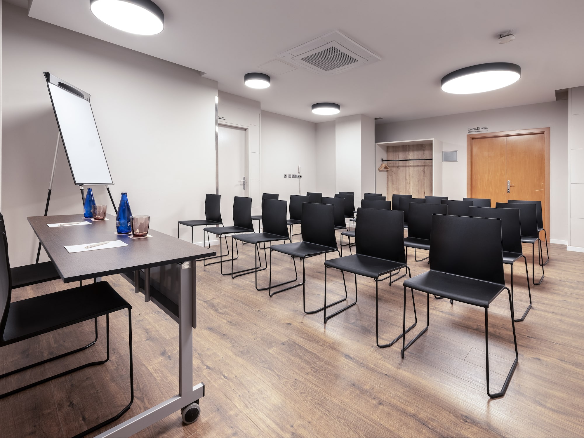 a room with chairs and a white board.
