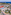 Aerial view: Mediterranean coastal resort with pools, hotel, and sandy beach.