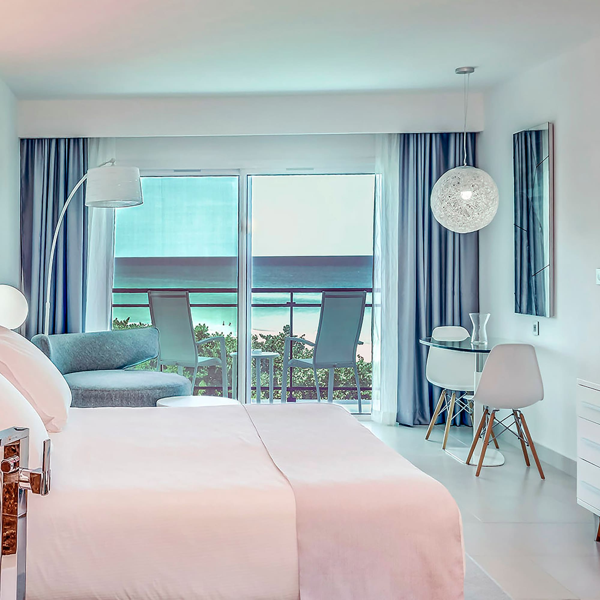 a bedroom with a bed and a table and chairs