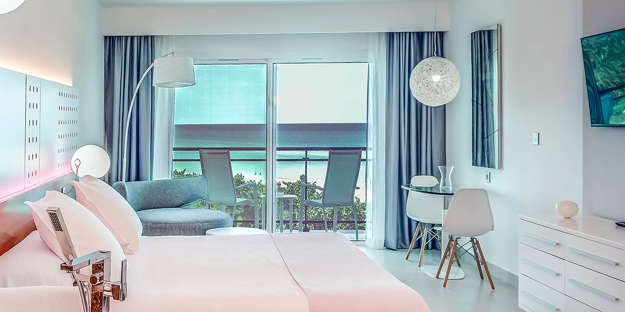 a bedroom with a bed and a table and chairs