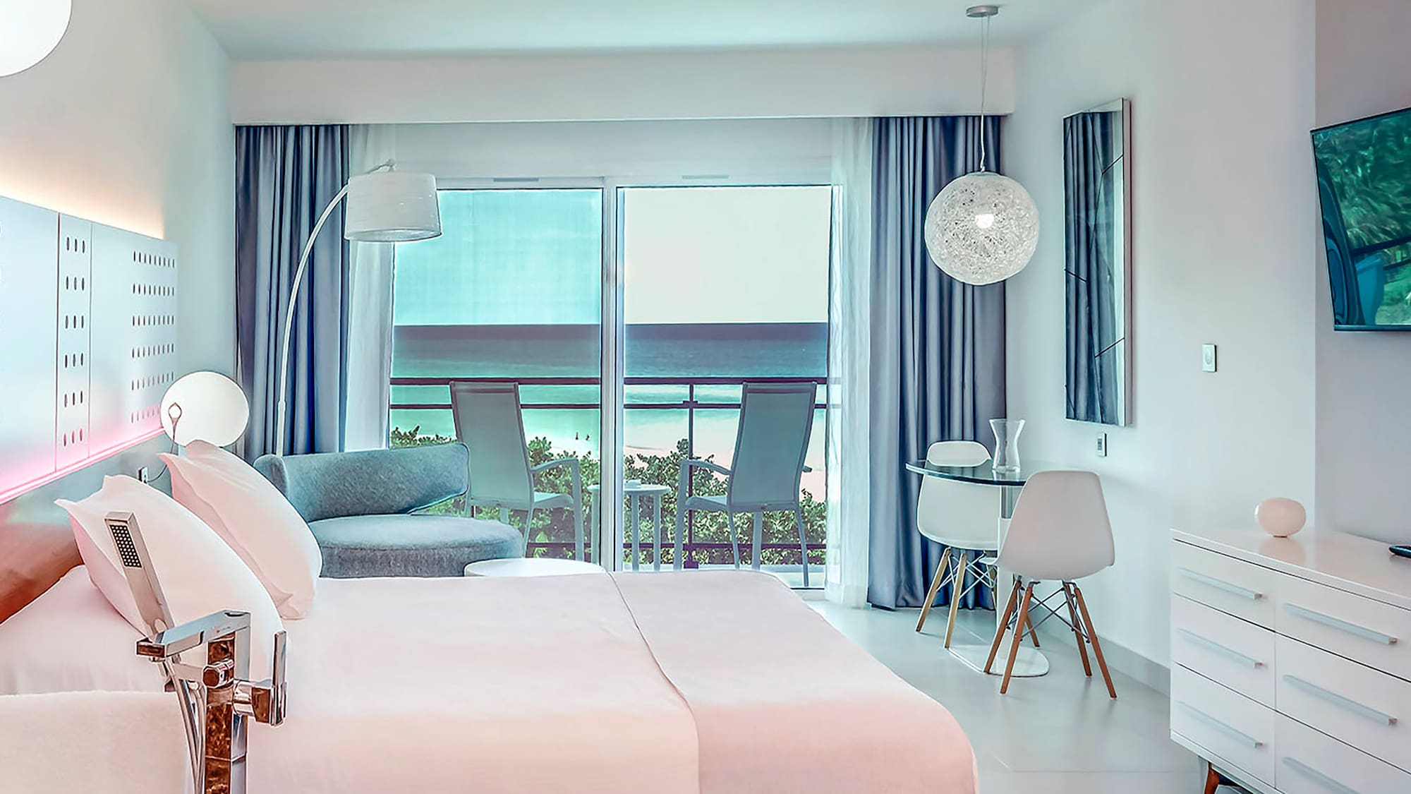 a bedroom with a bed and a table and chairs