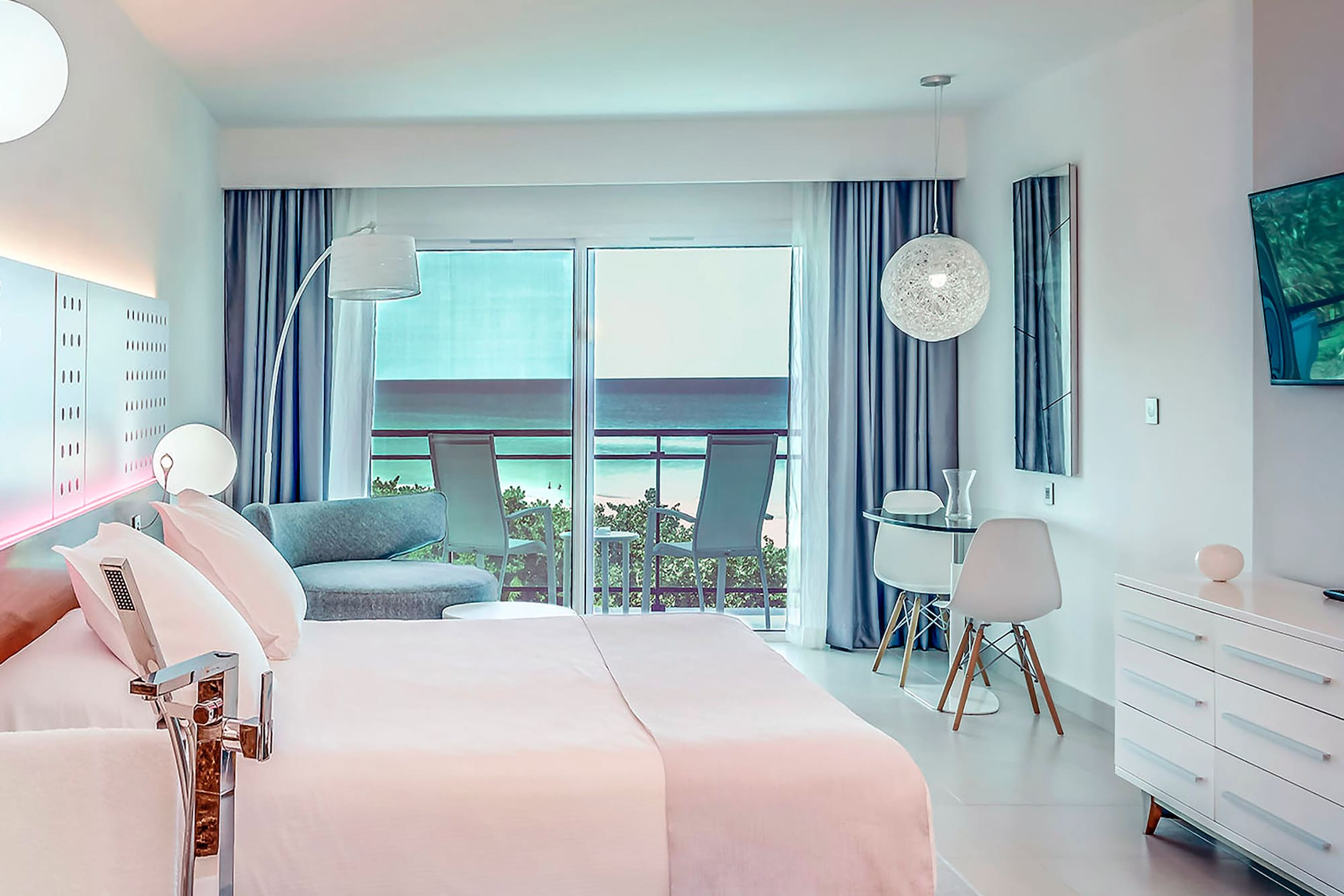 a bedroom with a bed and a table and chairs