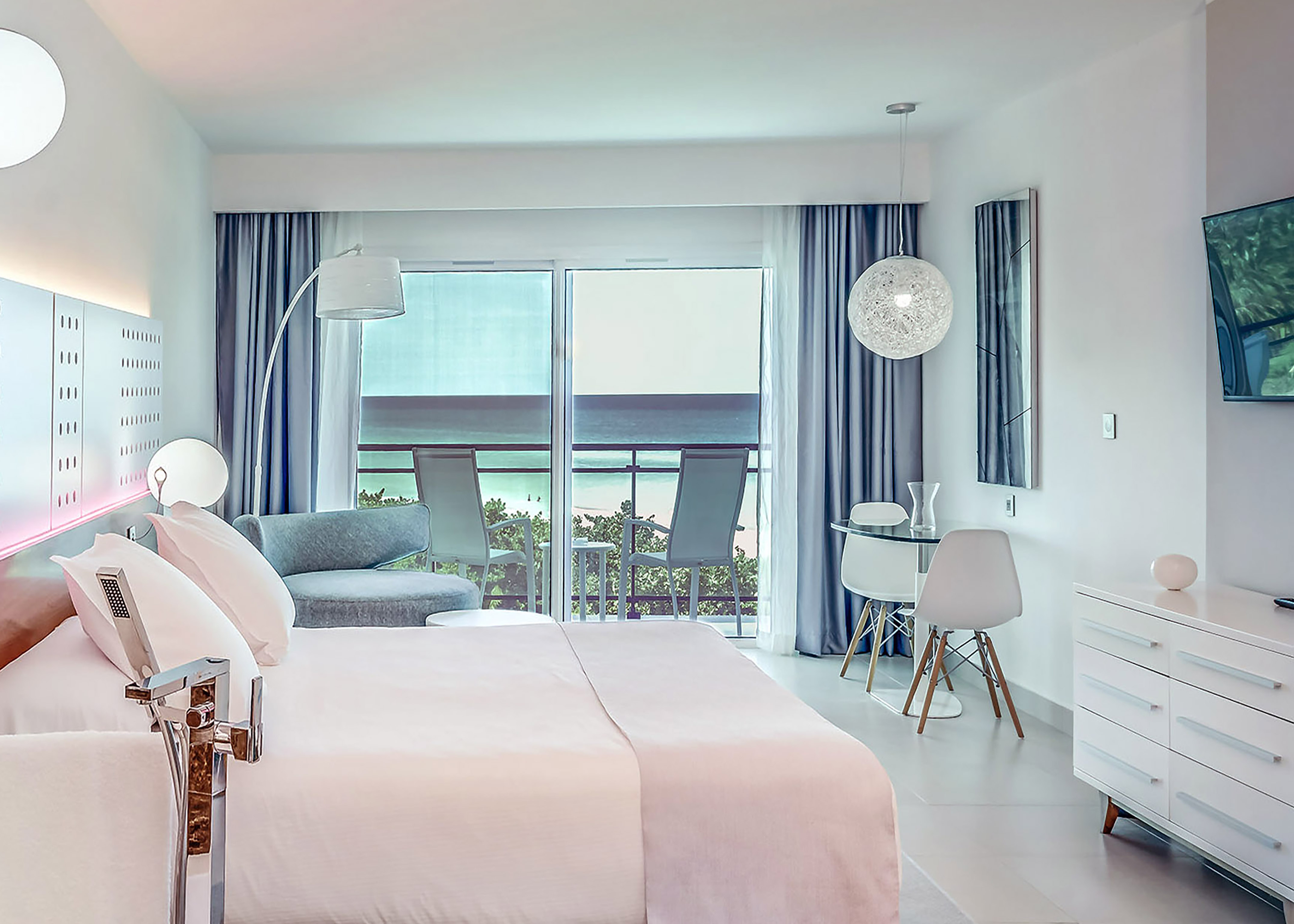 a bedroom with a bed and a table and chairs