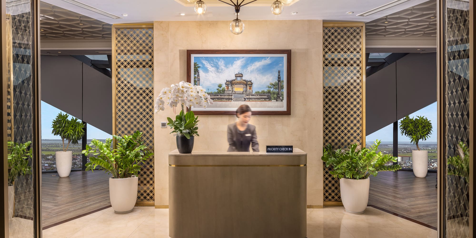 a woman standing at a reception desk in a hotel