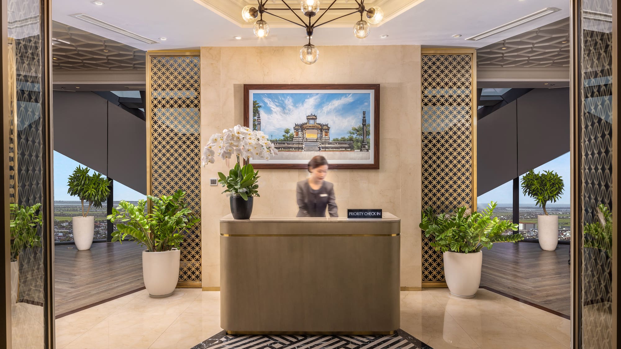 a woman standing at a reception desk in a hotel
