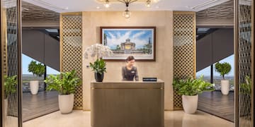 a woman standing at a reception desk in a hotel
