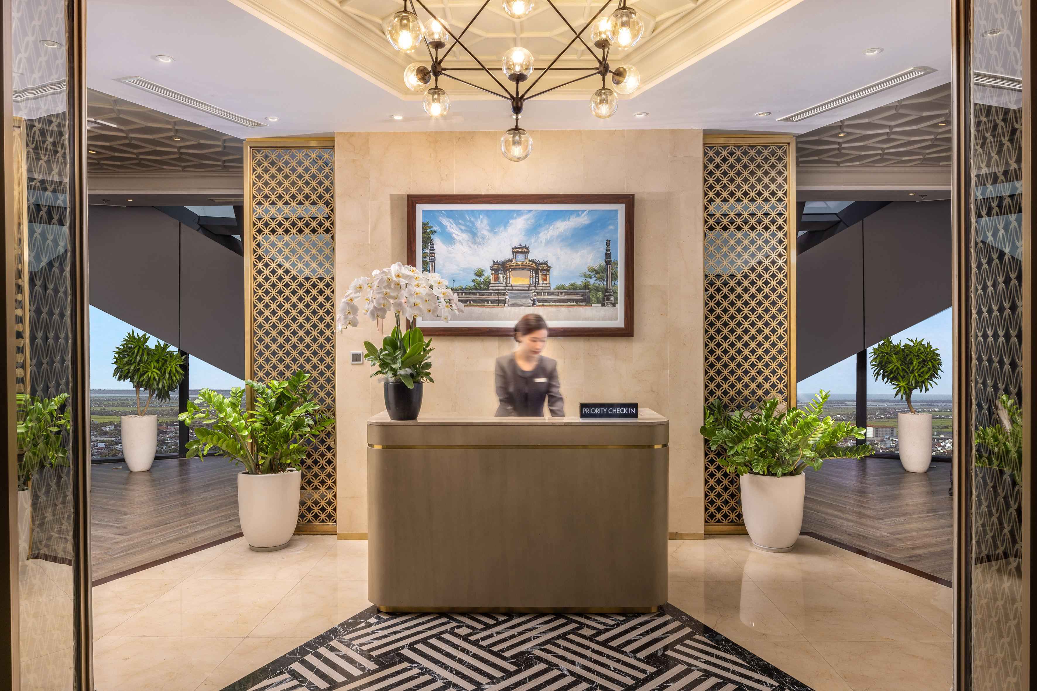 a woman standing at a reception desk in a hotel