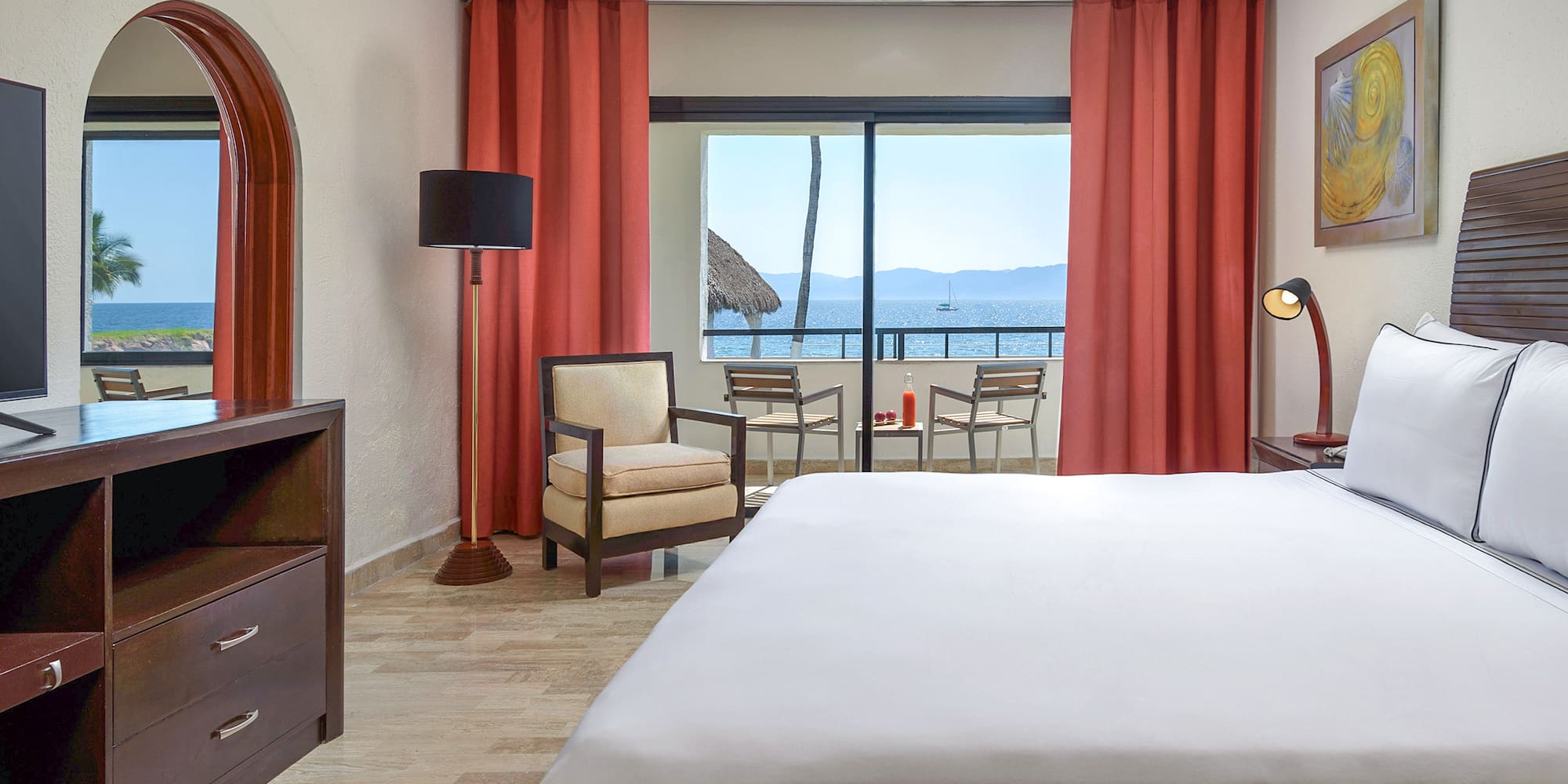 a room with a bed and chairs and a table and chairs