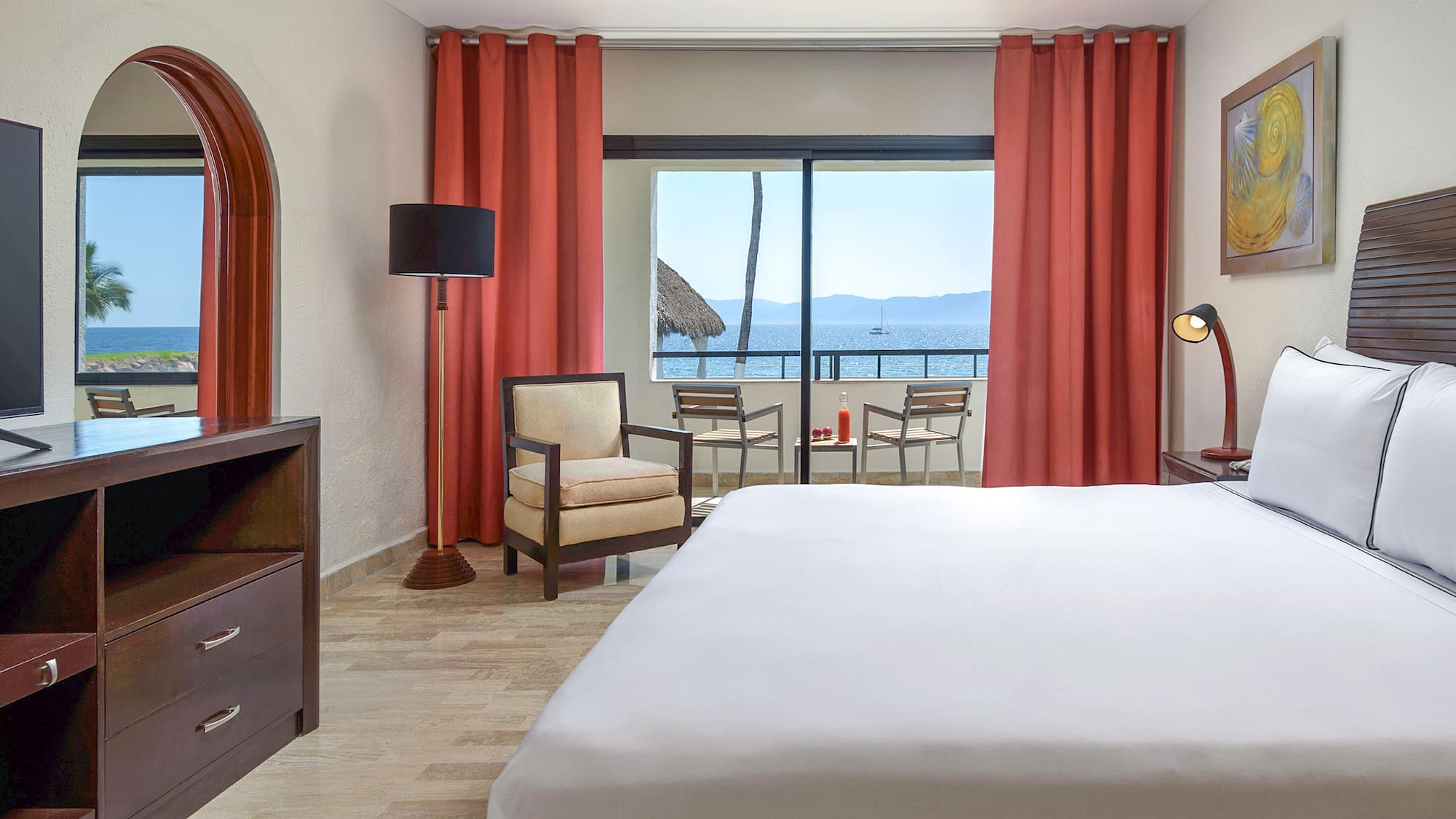 a room with a bed and chairs and a table and chairs