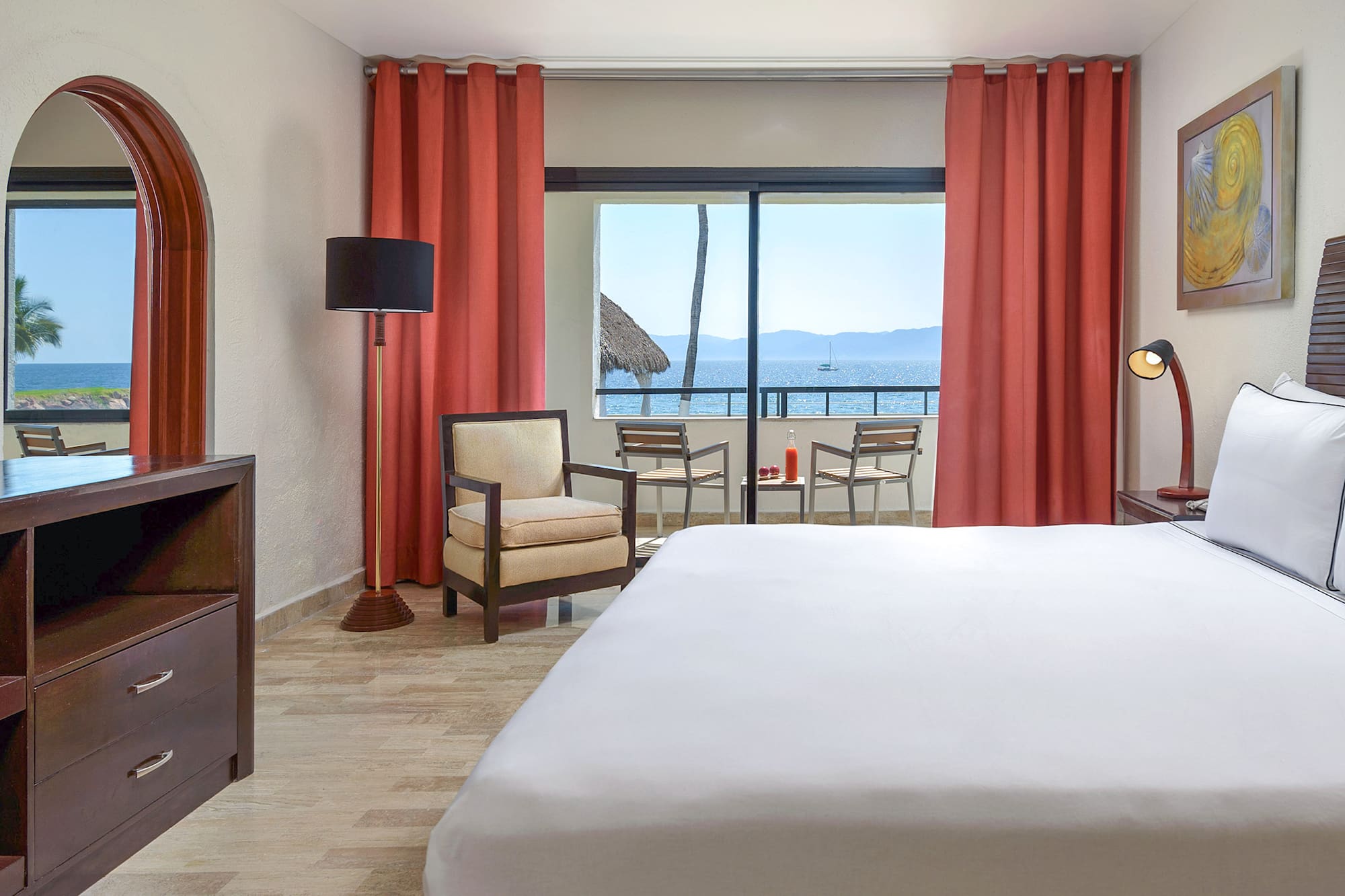 a room with a bed and chairs and a table and chairs