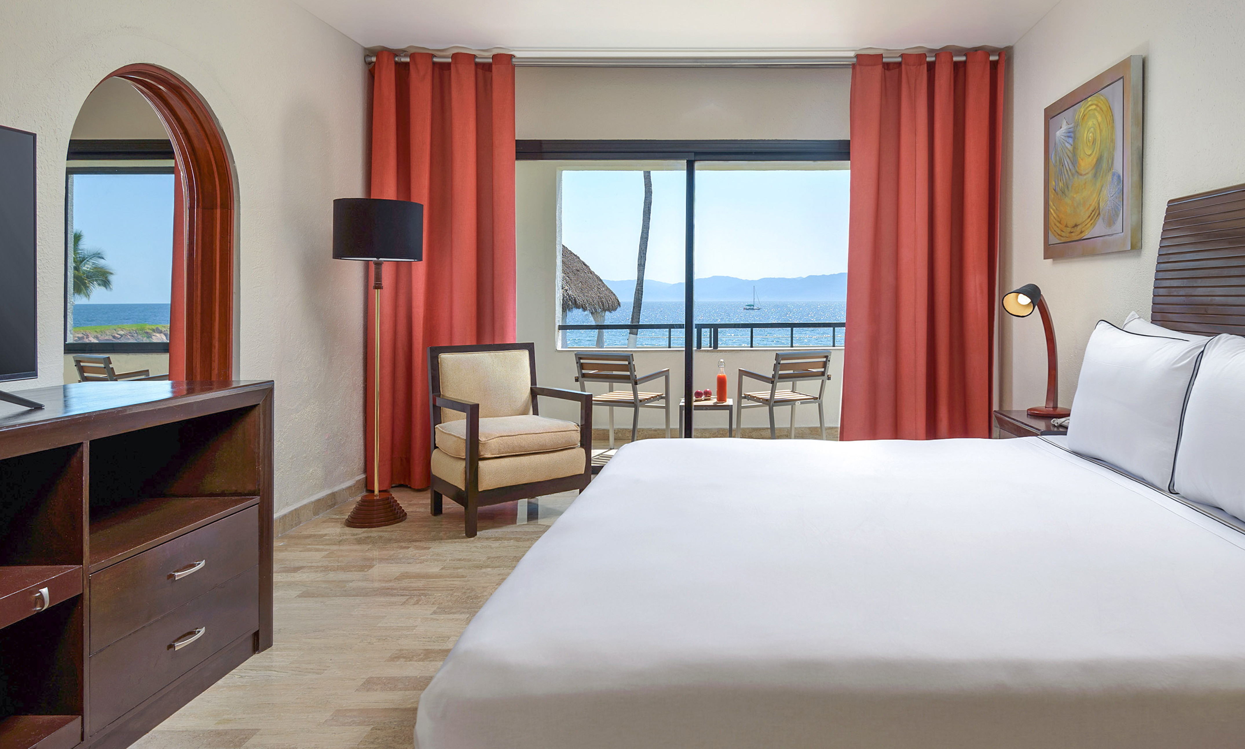 a room with a bed and chairs and a table and chairs