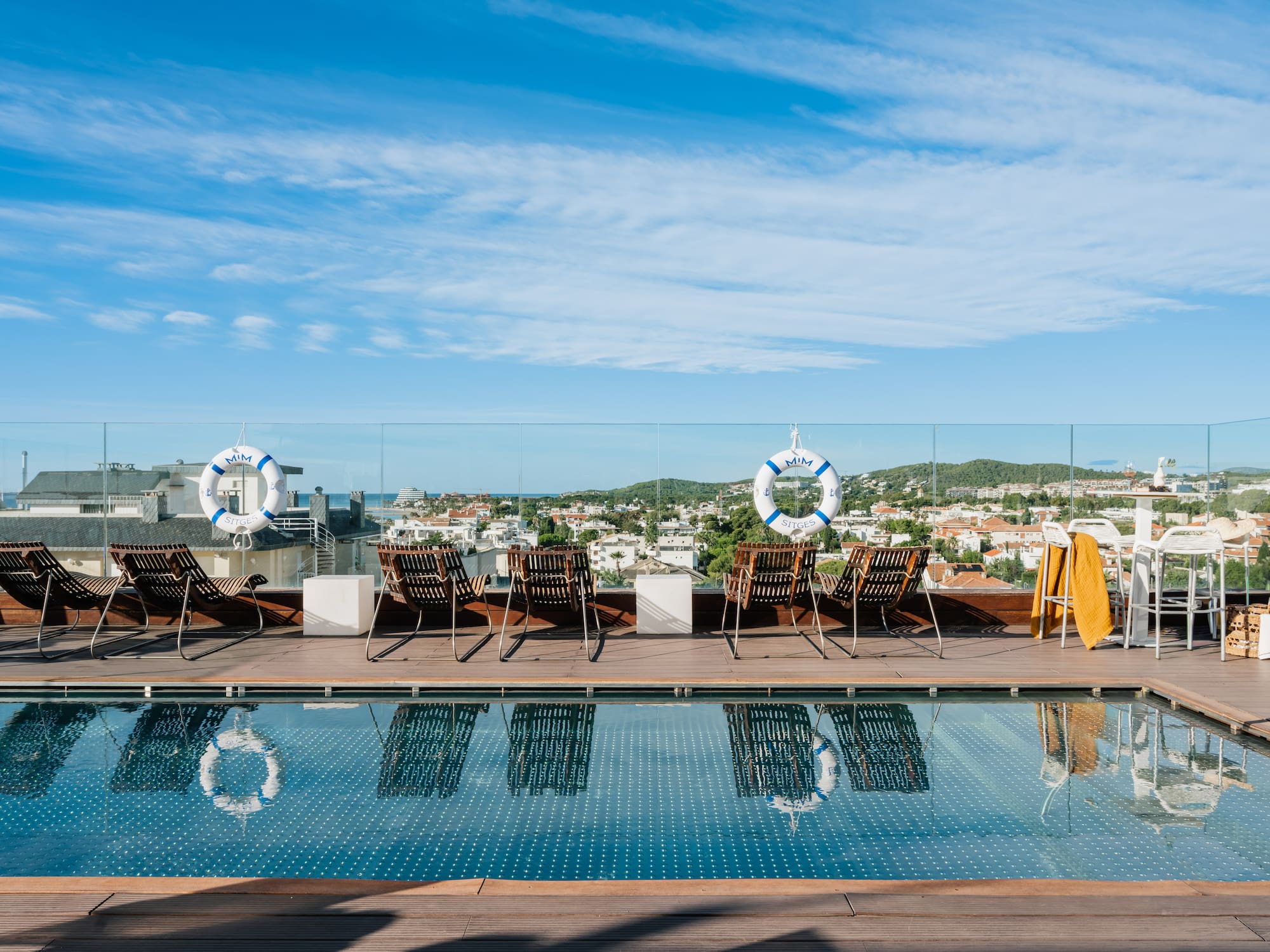 a pool with chairs and life preservers on it