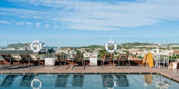 a pool with chairs and life preservers on it