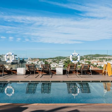 a pool with chairs and life preservers on it