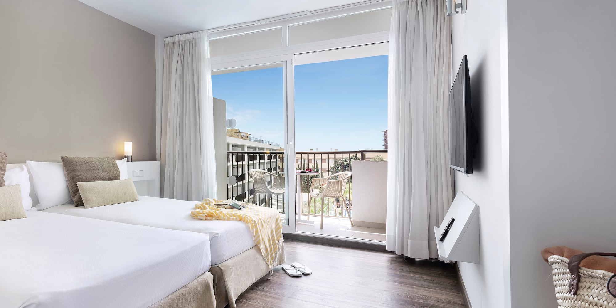 a room with a large window and a balcony