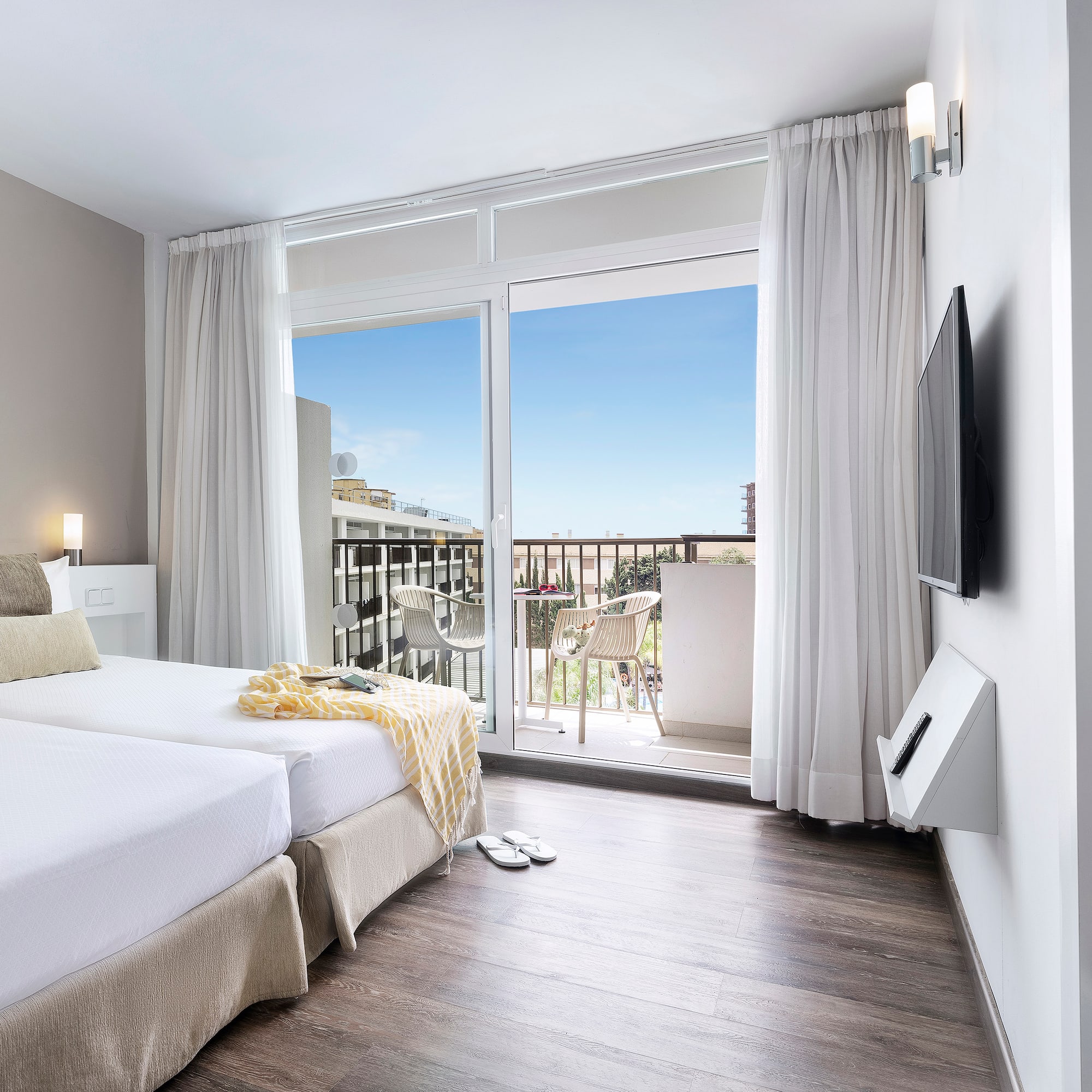 a room with a large window and a balcony