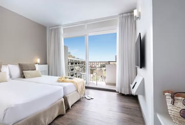a room with a large window and a balcony