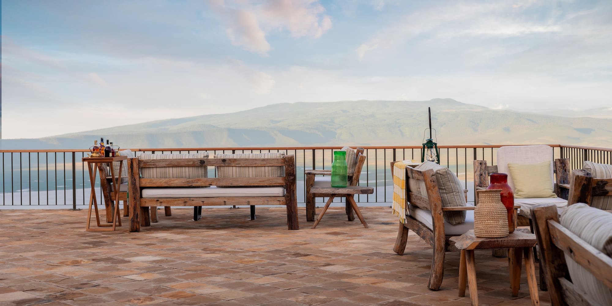 a patio with a view of mountains and a blue sky