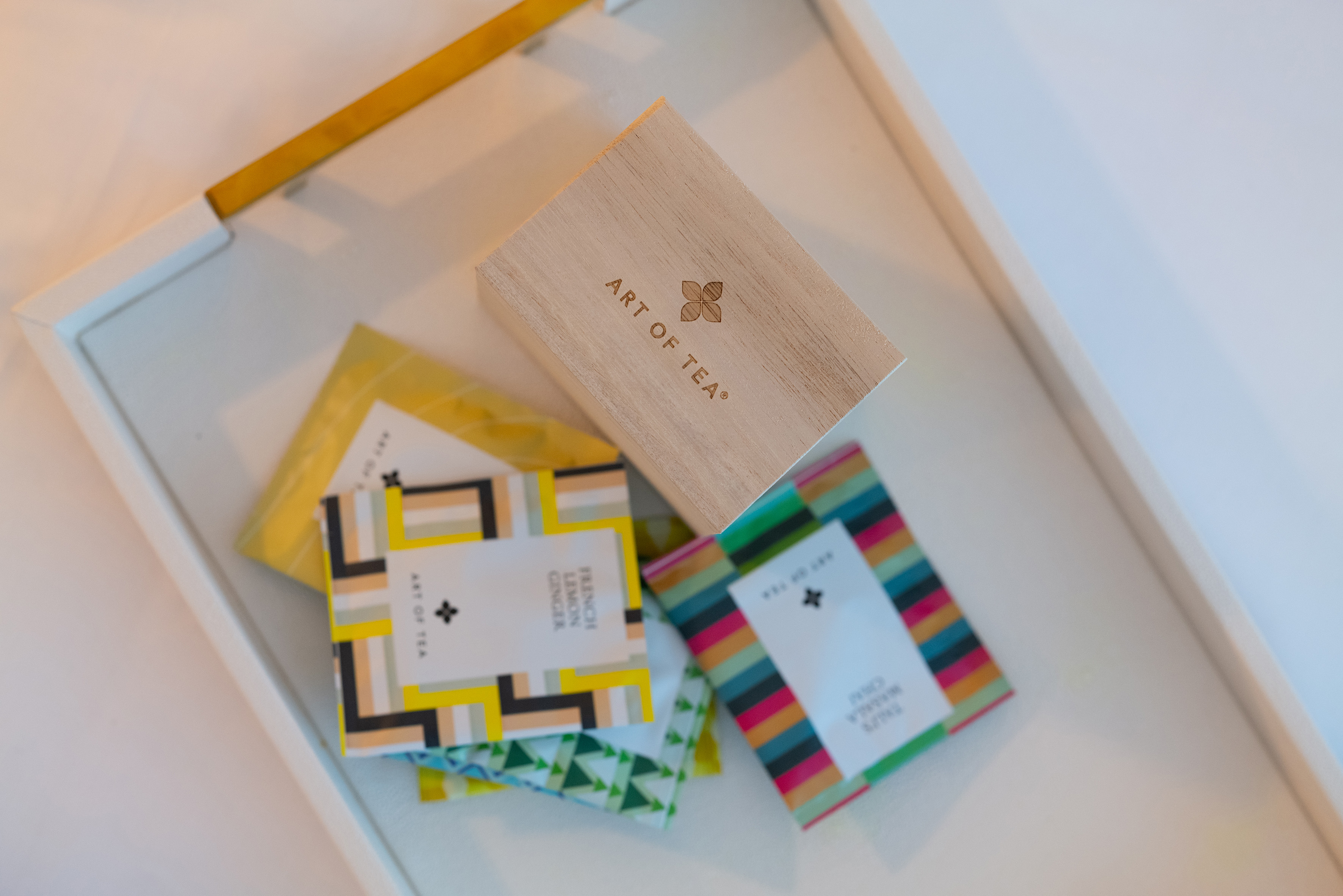 a box featuring a logo beside a pile of vibrant cards