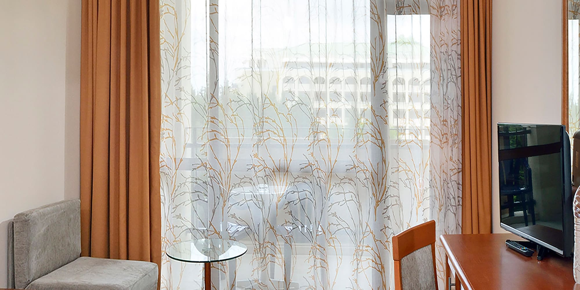 a room with a desk and a television