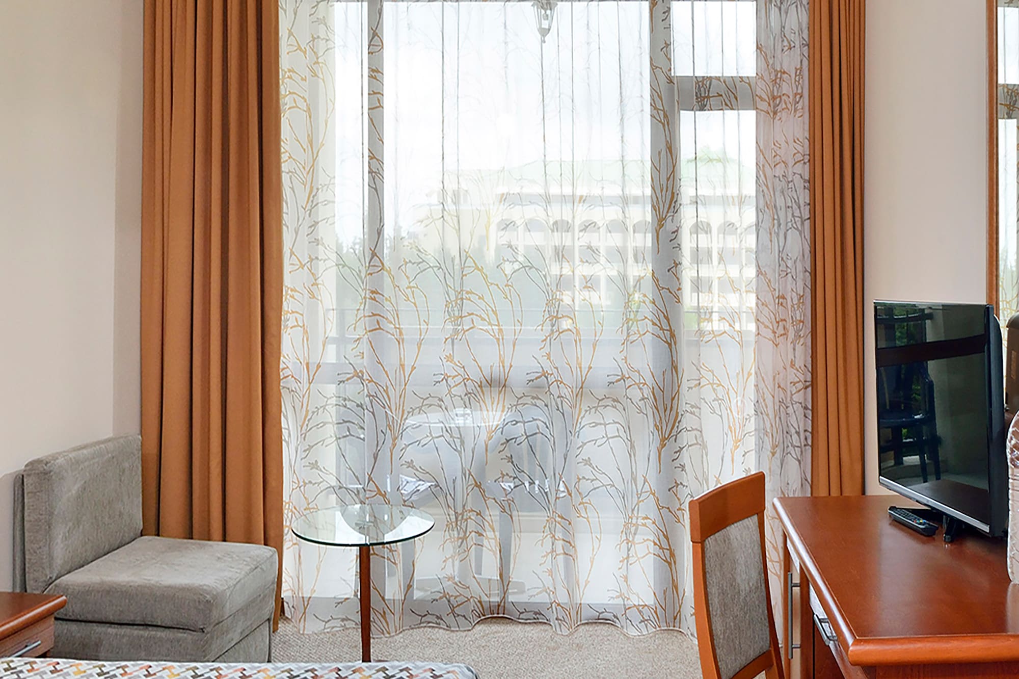 a room with a desk and a television