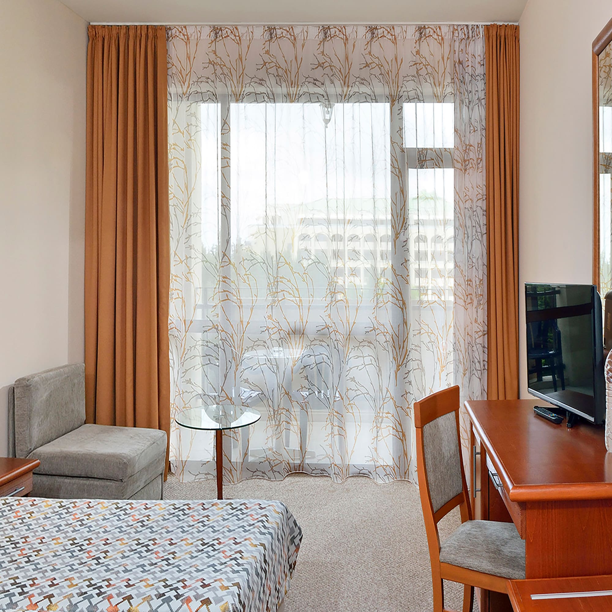 a room with a desk and a television