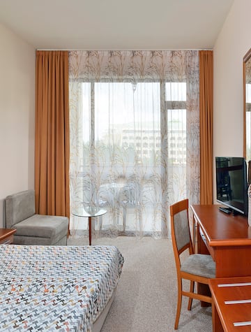 a room with a desk and a television