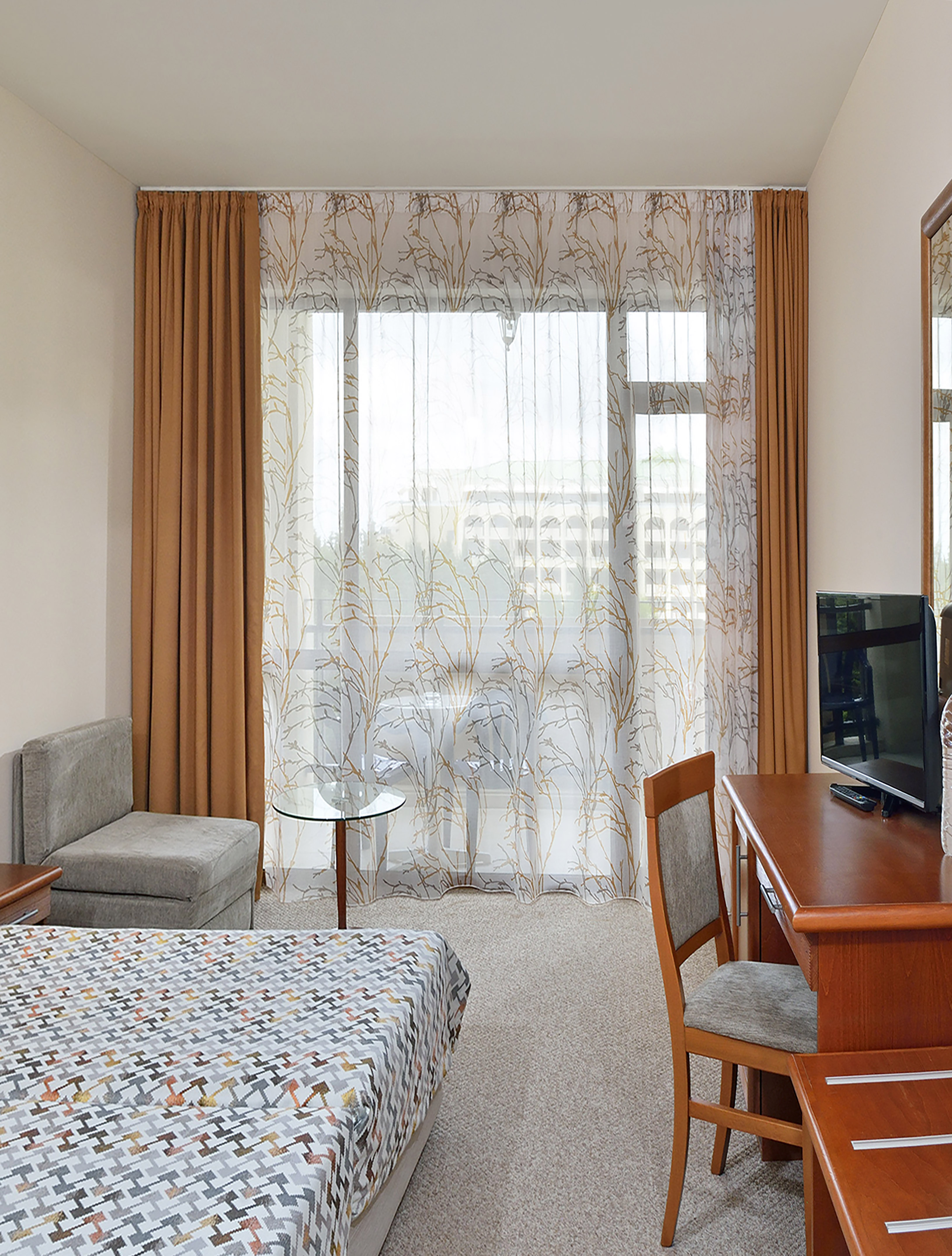 a room with a desk and a television