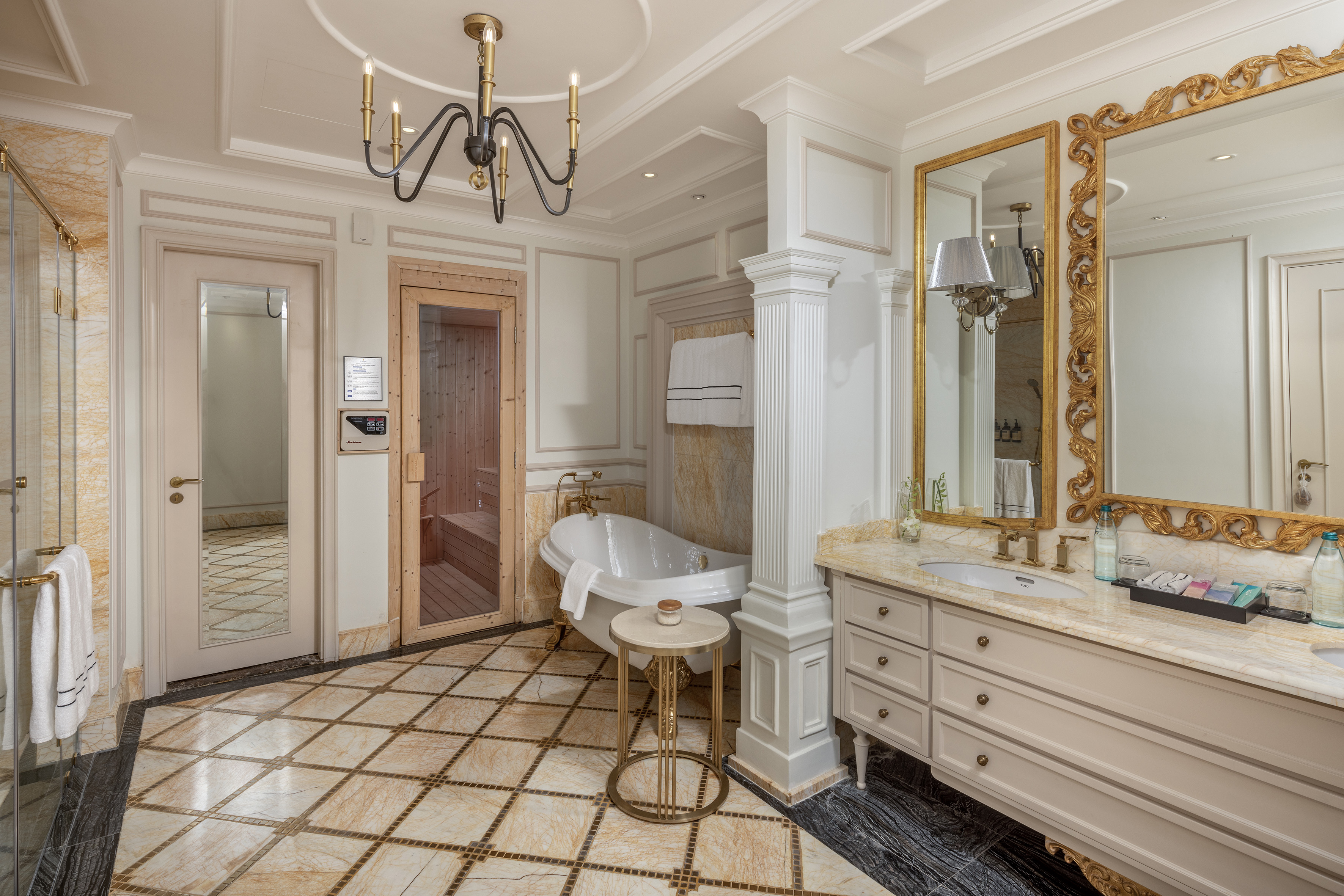 Luxurious bathroom with freestanding tub, built-in sauna, and marble vanity.