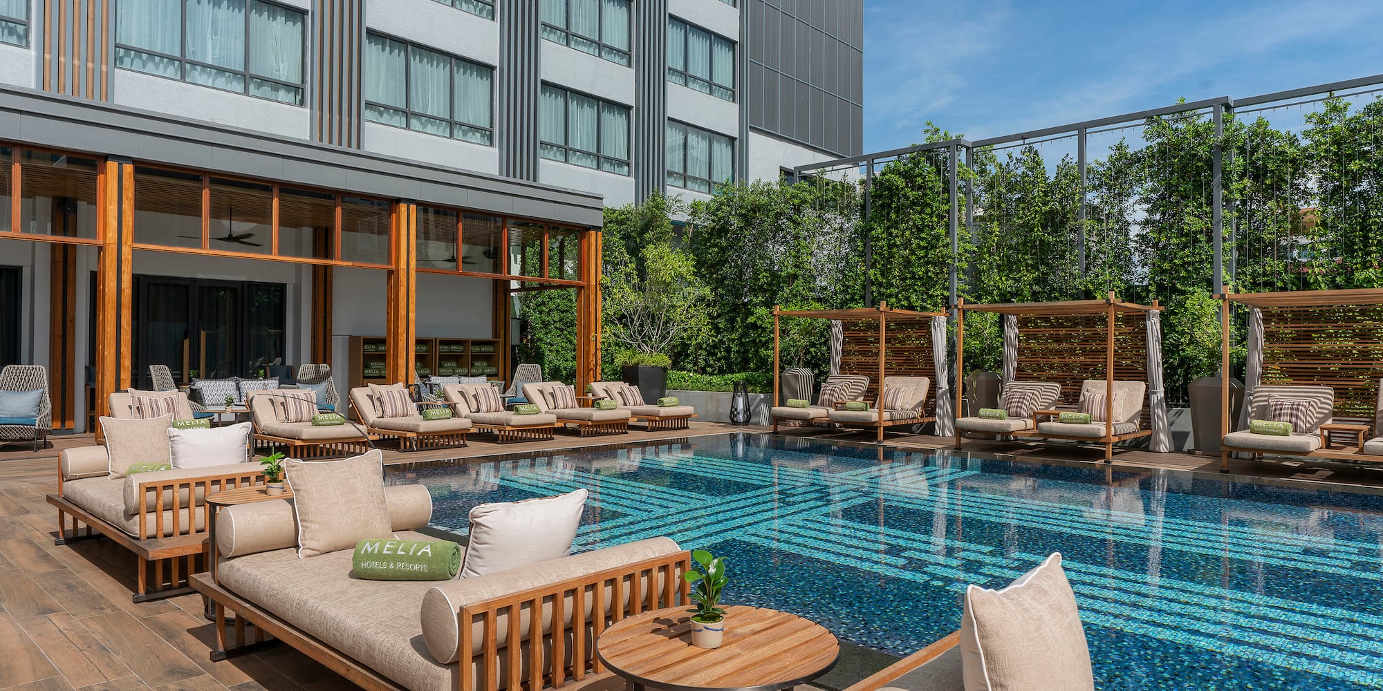 a pool with lounge chairs and tables