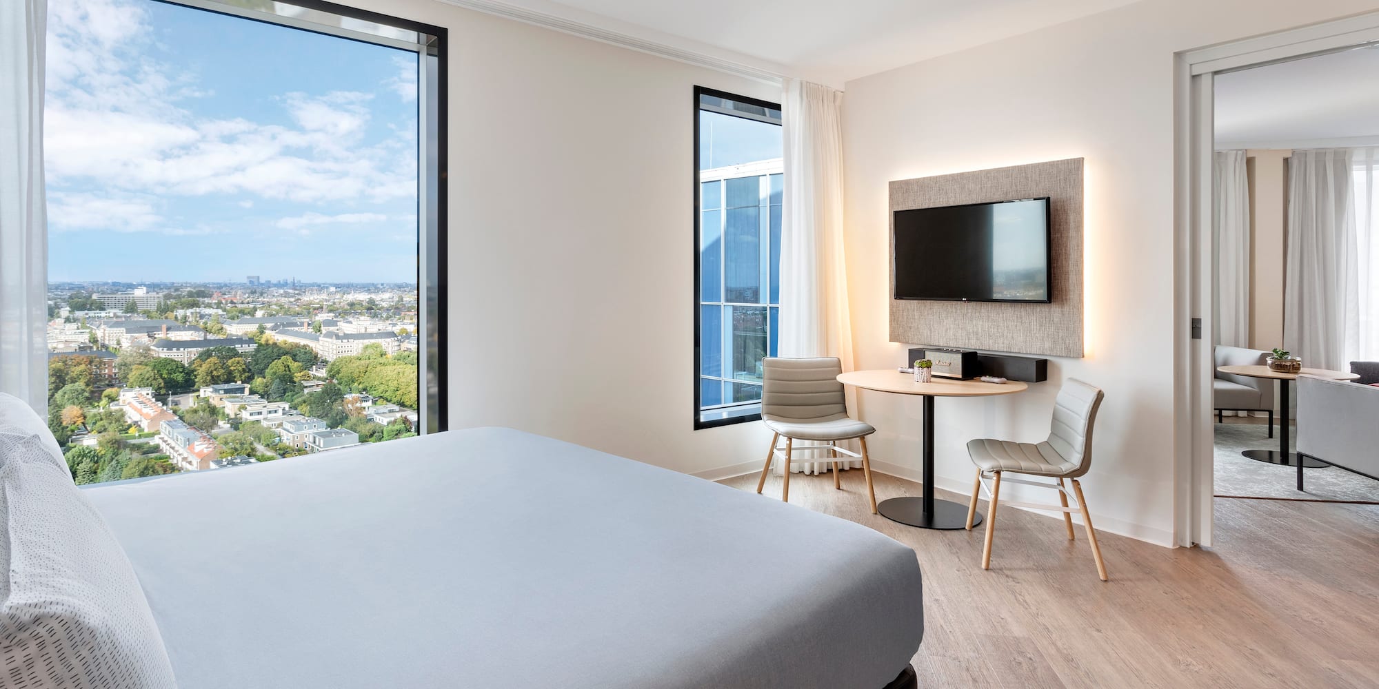 a room with a bed and a table and chairs