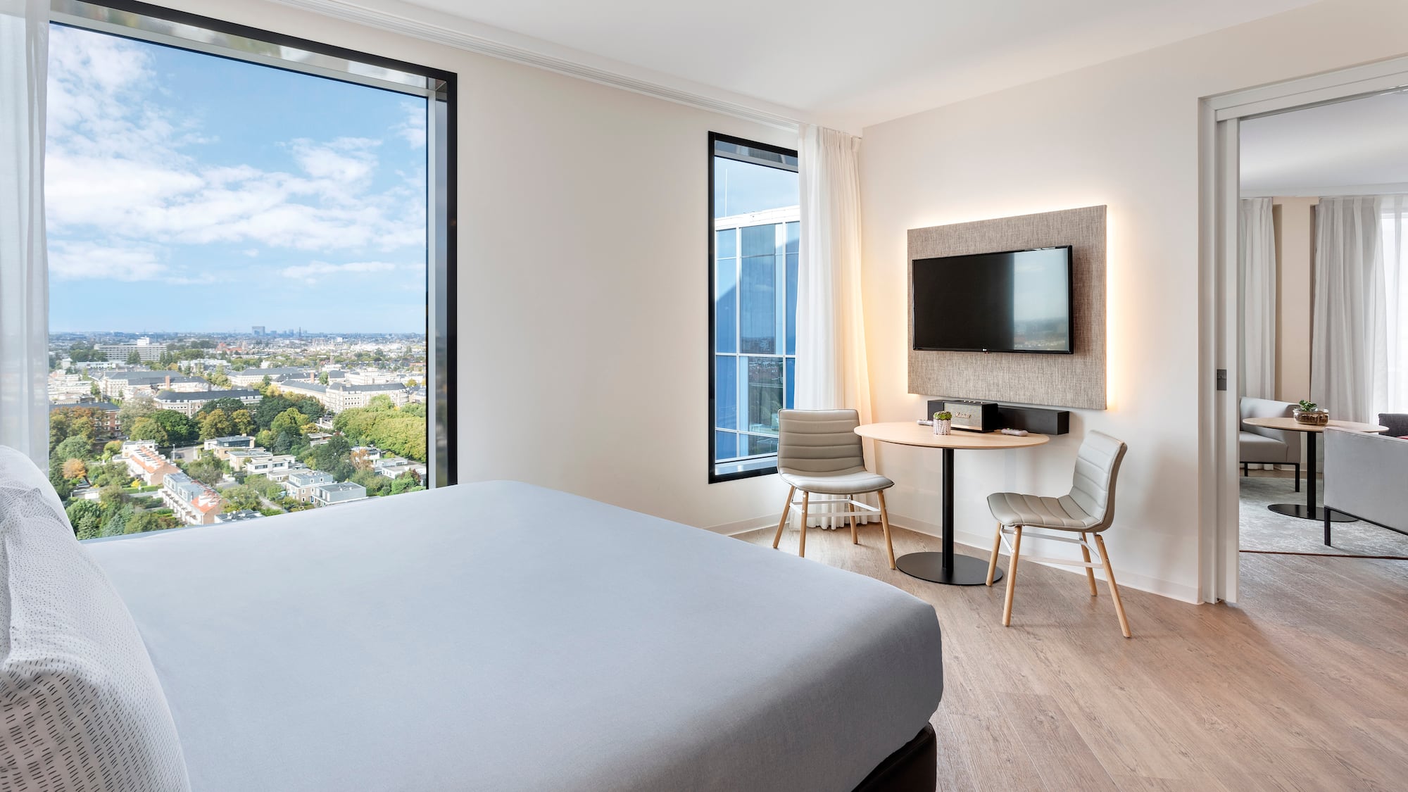 a room with a bed and a table and chairs