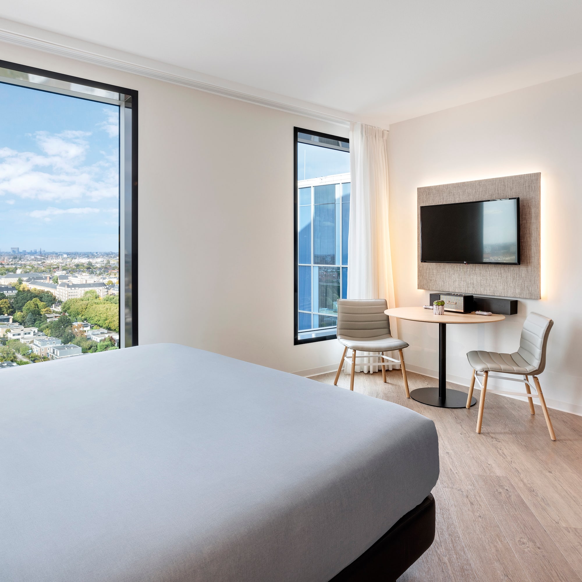 a room with a bed and a table and chairs