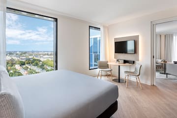 a room with a bed and a table and chairs