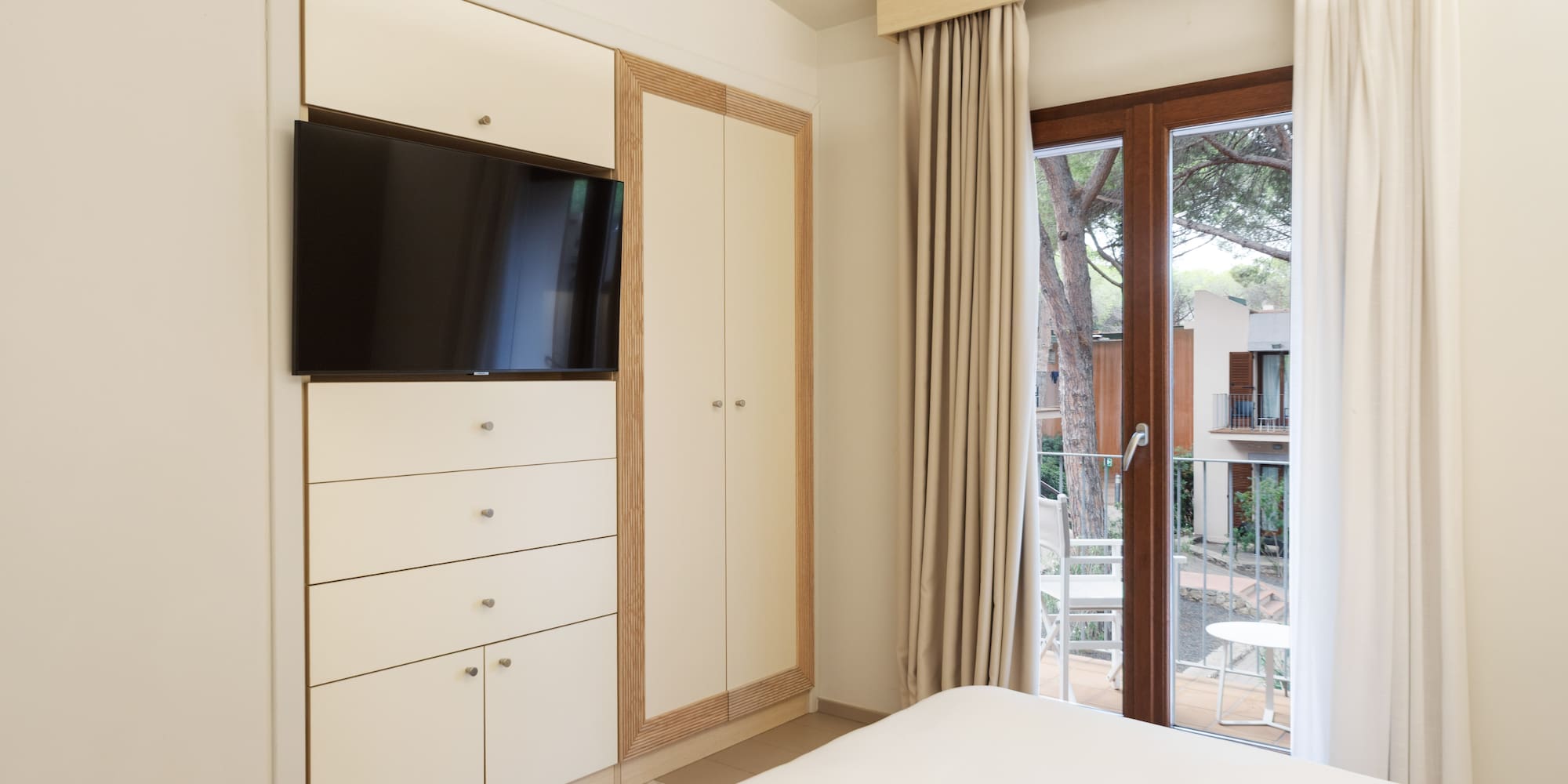 a bedroom with a television and a sliding glass door