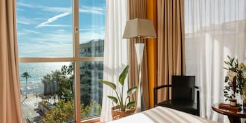 a room with a bed and a lamp