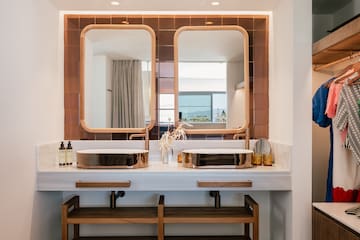 a bathroom with two sinks and a mirror
