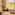 Serene spa with two massage beds, rolled towels, mural, and lush nature view.