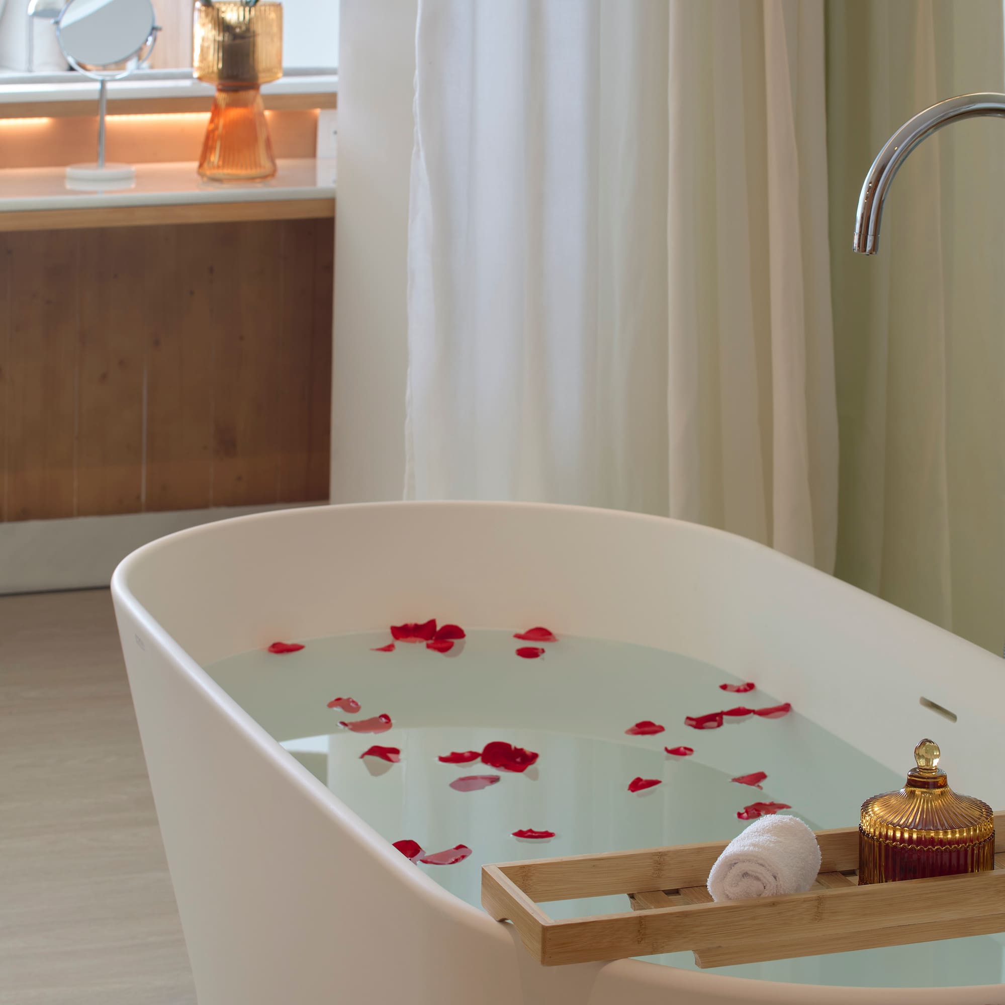 a bathtub with water and rose petals