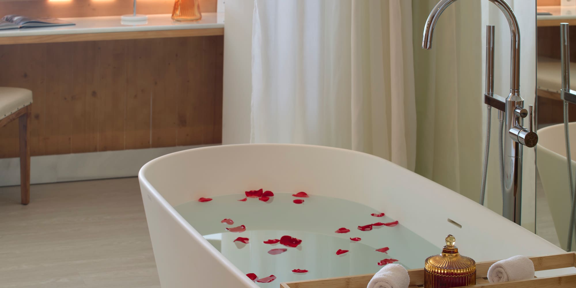 a bathtub with water and rose petals