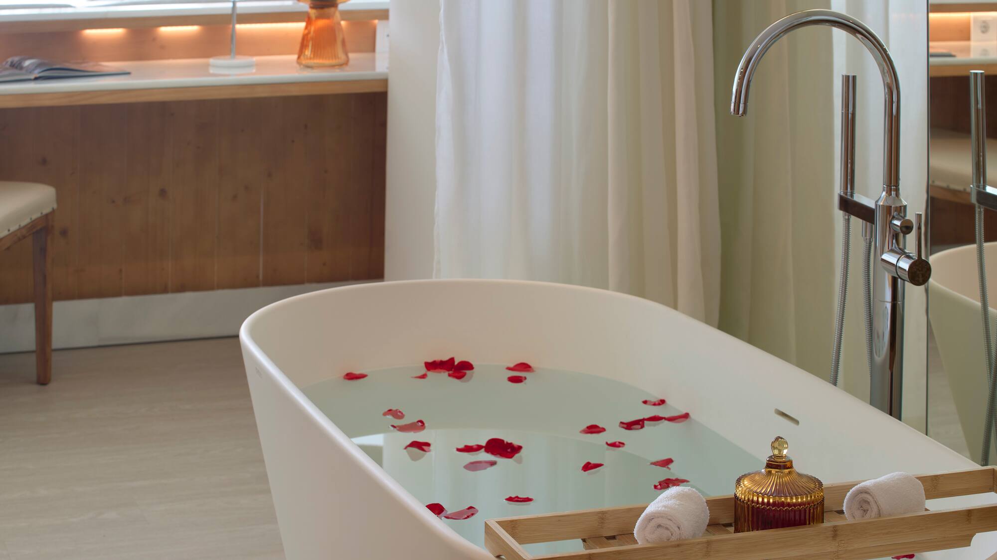 a bathtub with water and rose petals