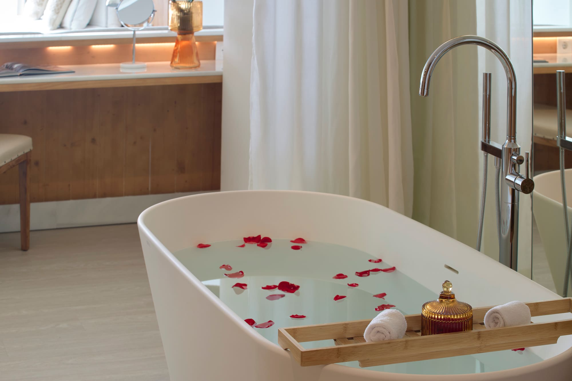a bathtub with water and rose petals