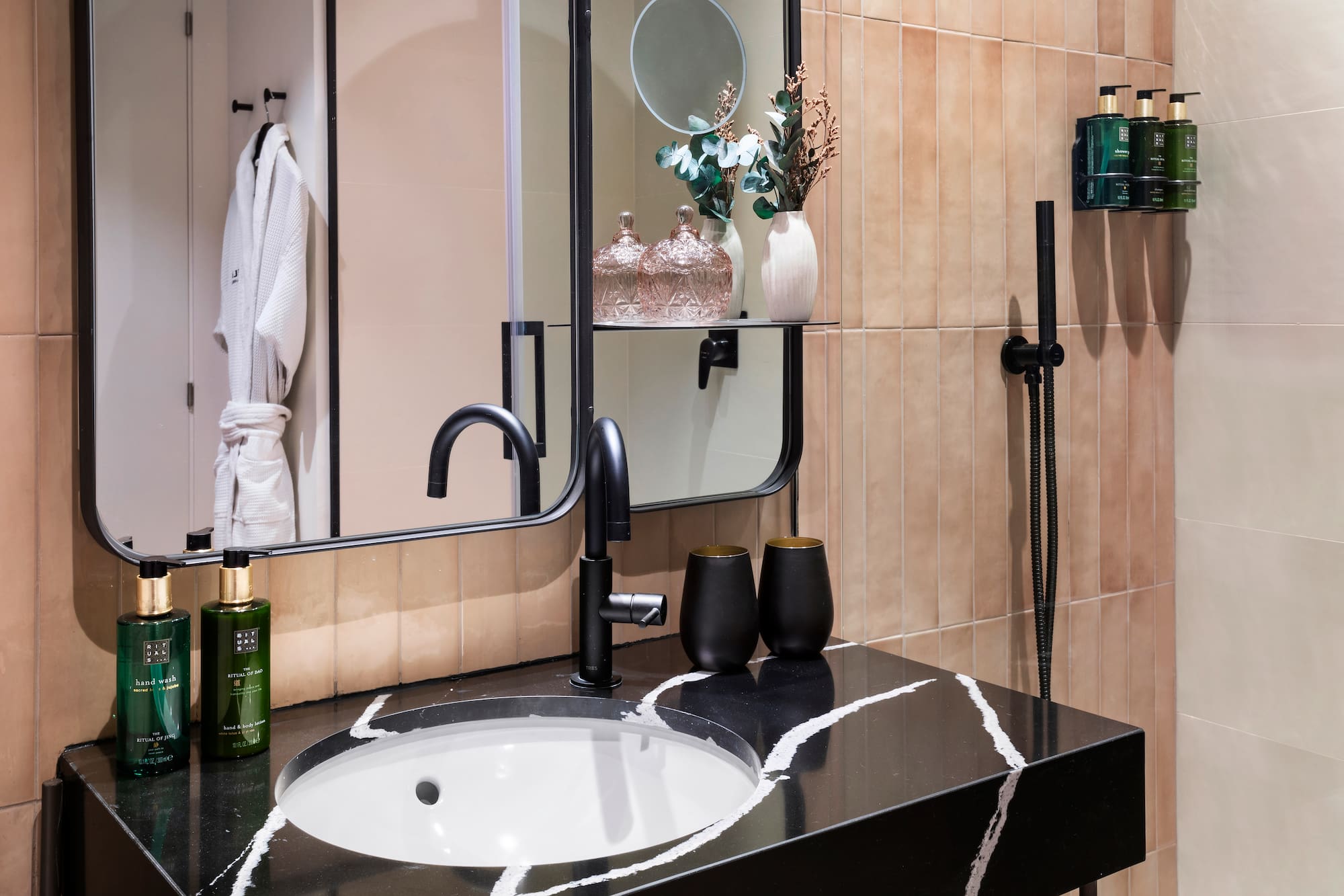 a bathroom with a black sink and a mirror