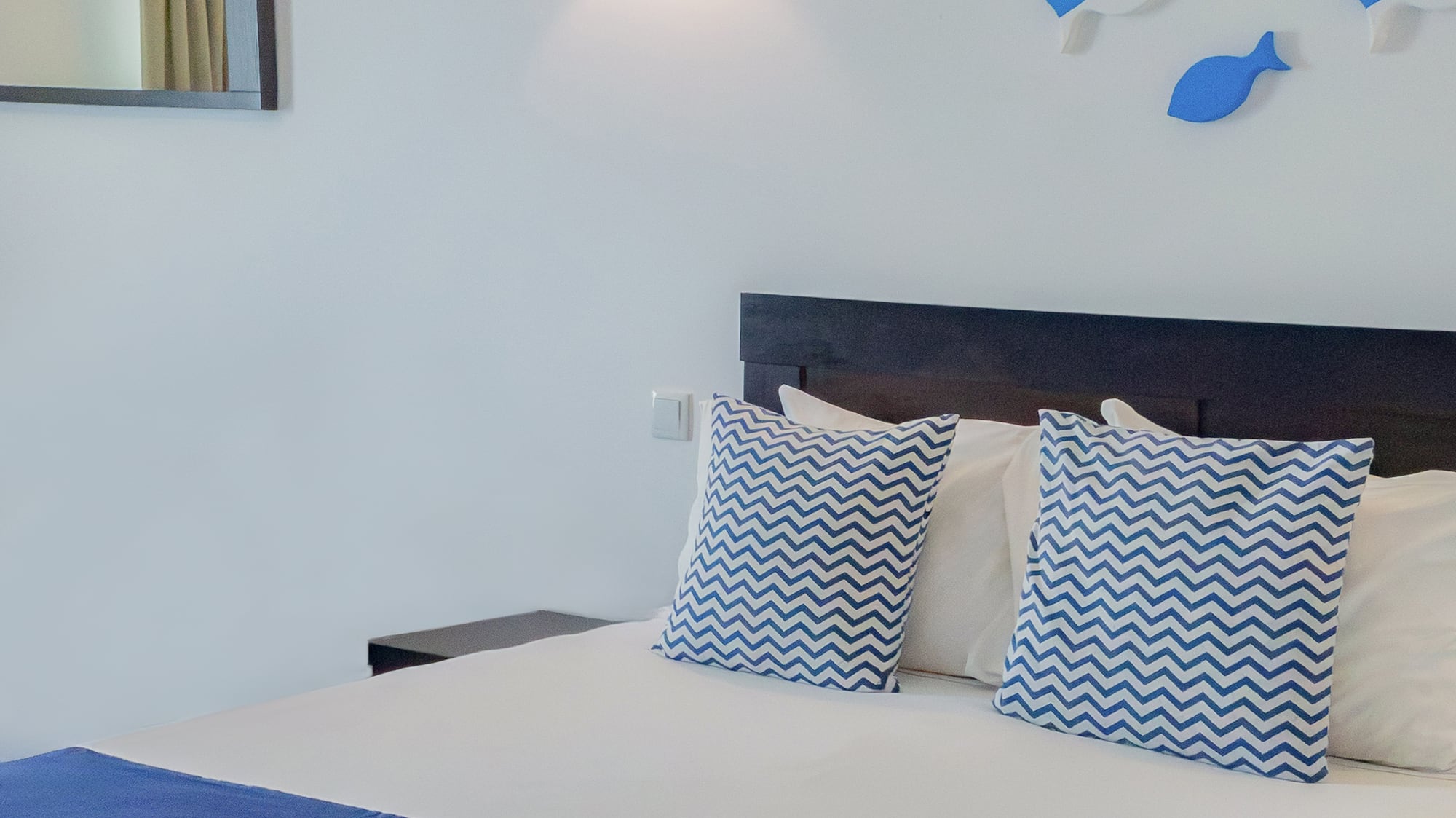 a bed with blue and white pillows