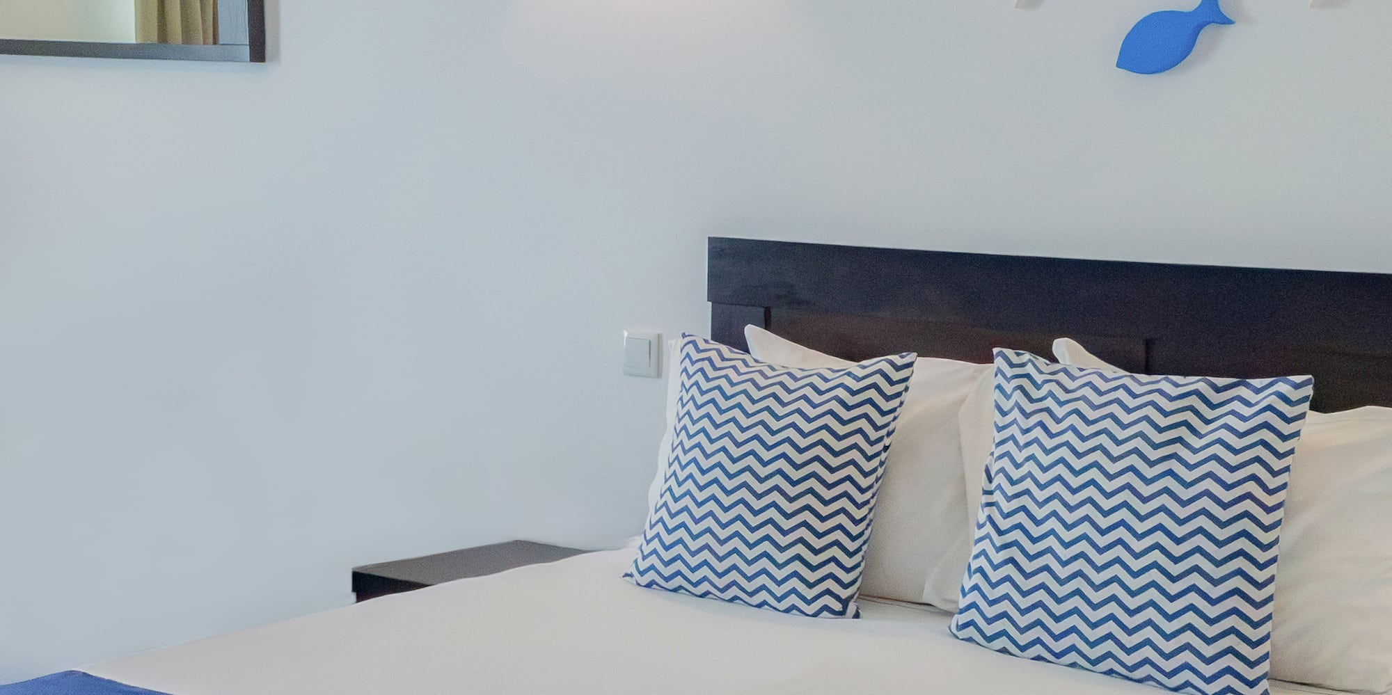 a bed with blue and white pillows