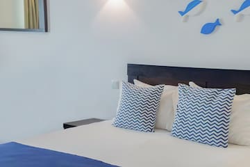 a bed with blue and white pillows