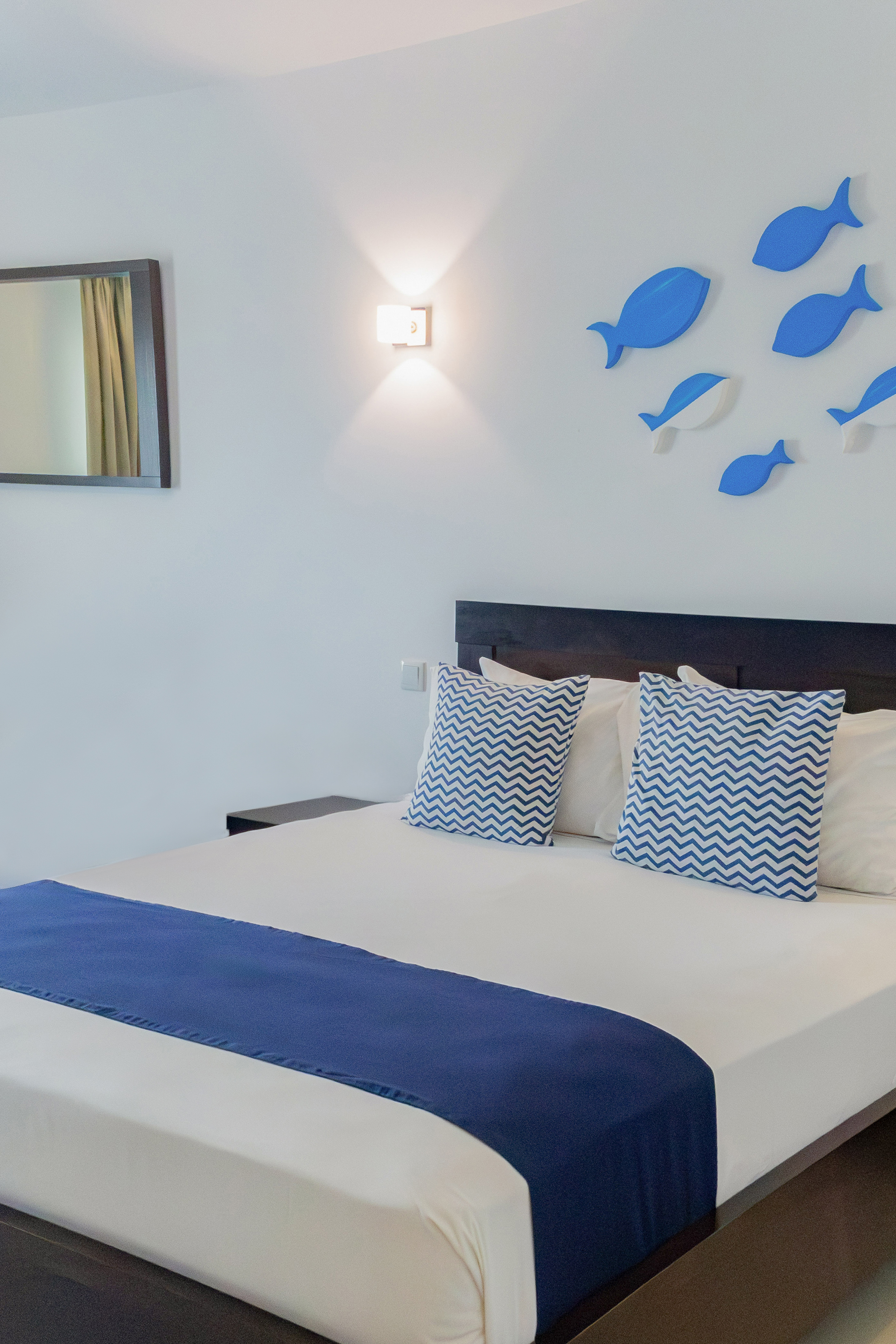 a bed with blue and white pillows