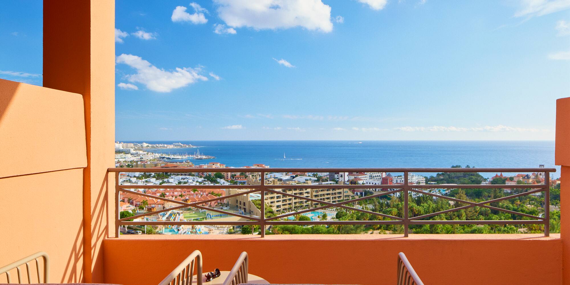 a balcony with a view of the ocean and a city